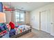 Well-lit bedroom with a comfortable bed, blue accents, and a picturesque view from the window at 7935 Pandora Sky St # 393, North Las Vegas, NV 89084