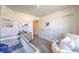 Neutral Bedroom with white crib, cozy chair, and nautical accents at 7935 Pandora Sky St # 393, North Las Vegas, NV 89084