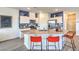 Bright kitchen featuring stainless appliances, white cabinets, and a spacious island at 7935 Pandora Sky St # 393, North Las Vegas, NV 89084