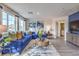 This bright living room features a comfortable blue sectional, stylish decor, and plenty of natural light at 7945 Pandora Sky St # 371, North Las Vegas, NV 89084