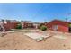 View of the backyard with a patio area, landscaping, and an outbuilding at 812 Pyramid Dr, Las Vegas, NV 89107