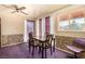 Dining area features a modern table set, natural light, and purple carpeting at 812 Pyramid Dr, Las Vegas, NV 89107
