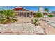 Cozy single-story home featuring desert landscaping, a stone chimney and stone facade accents at 812 Pyramid Dr, Las Vegas, NV 89107