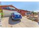 A cozy single-story home with an attached garage and a private driveway under a clear, sunny sky at 812 Pyramid Dr, Las Vegas, NV 89107
