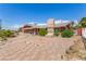 Charming single-story home with stone chimney, stone facade and brick paver driveway at 812 Pyramid Dr, Las Vegas, NV 89107