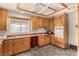 Functional kitchen with wooden cabinets, neutral countertops, and standard appliances at 812 Pyramid Dr, Las Vegas, NV 89107