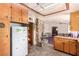 Well-lit kitchen with wooden cabinets, pantry shelves, and an adjacent dining area at 812 Pyramid Dr, Las Vegas, NV 89107