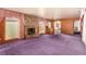 Spacious living room featuring a stone fireplace, wood paneling, and large windows at 812 Pyramid Dr, Las Vegas, NV 89107