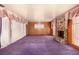 Spacious living room featuring a stone fireplace, wood paneling, and large windows at 812 Pyramid Dr, Las Vegas, NV 89107