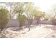 Spacious backyard with mature trees, shrubs, and landscape lighting at 825 Cornerstone Pl, North Las Vegas, NV 89031