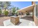 Relaxing backyard featuring a covered patio with ceiling fans and a built-in grill at 825 Cornerstone Pl, North Las Vegas, NV 89031