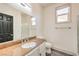 Bright bathroom featuring granite countertops, white cabinetry, and a framed mirror at 825 Cornerstone Pl, North Las Vegas, NV 89031