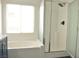 Modern bathroom features a bathtub and separate shower at 825 Cornerstone Pl, North Las Vegas, NV 89031