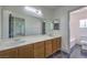 Spacious bathroom featuring double sinks, wood cabinets and tile flooring at 825 Cornerstone Pl, North Las Vegas, NV 89031
