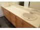 Bathroom vanity featuring double sinks, light countertops, and wood cabinets with silver hardware at 825 Cornerstone Pl, North Las Vegas, NV 89031