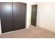 Bedroom closet with sliding doors and a view into the hallway, featuring neutral carpet at 825 Cornerstone Pl, North Las Vegas, NV 89031