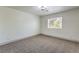 Bright, carpeted bedroom with a modern ceiling light fixture and a window, creating a cozy space at 825 Cornerstone Pl, North Las Vegas, NV 89031