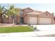 Charming two-story home featuring a tile roof, three-car garage and manicured front yard, creating a welcoming curb appeal at 825 Cornerstone Pl, North Las Vegas, NV 89031
