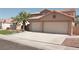 Spacious home featuring a terra cotta roof, a three-car garage, and tasteful desert landscaping at 825 Cornerstone Pl, North Las Vegas, NV 89031