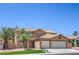Charming two-story home featuring a desert landscape, tile roof, and a two-car garage at 825 Cornerstone Pl, North Las Vegas, NV 89031