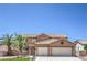 Charming two-story home featuring a desert landscape, tile roof, and a two-car garage at 825 Cornerstone Pl, North Las Vegas, NV 89031