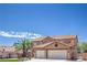 A two-story home boasts a tile roof and a three-car garage with desert landscaping at 825 Cornerstone Pl, North Las Vegas, NV 89031
