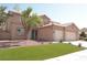 Inviting two-story home with a three-car garage, well-maintained landscaping, and a classic tile roof, offering comfort and style at 825 Cornerstone Pl, North Las Vegas, NV 89031