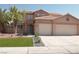 Charming two-story home with a tile roof, a well-manicured lawn, and a three-car garage at 825 Cornerstone Pl, North Las Vegas, NV 89031