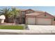Inviting two-story home showcasing a terra cotta roof, a three-car garage, and desert landscaping at 825 Cornerstone Pl, North Las Vegas, NV 89031