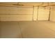 Spacious three-car garage with ample room for vehicles and storage on an epoxy-coated floor at 825 Cornerstone Pl, North Las Vegas, NV 89031