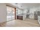 Modern kitchen boasts stainless appliances, a stylish island, and sliding door access to the backyard at 825 Cornerstone Pl, North Las Vegas, NV 89031