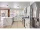 Bright kitchen with stainless appliances, white cabinets, stylish countertops and backyard access at 825 Cornerstone Pl, North Las Vegas, NV 89031