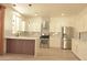 Modern kitchen featuring stainless steel appliances, white cabinetry, stylish backsplash, and a unique island design at 825 Cornerstone Pl, North Las Vegas, NV 89031