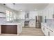 Modern kitchen features stainless appliances, white cabinets, herringbone tile backsplash, and a large island at 825 Cornerstone Pl, North Las Vegas, NV 89031