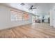 Spacious living room with wood-look floors that opens to a modern kitchen with stainless appliances at 825 Cornerstone Pl, North Las Vegas, NV 89031