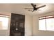 Bright living room featuring a decorative fireplace and modern ceiling fan at 825 Cornerstone Pl, North Las Vegas, NV 89031