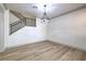 Open concept living room with modern light fixture and metal staircase at 825 Cornerstone Pl, North Las Vegas, NV 89031