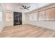 Stylish living room boasts wood-look floors, a modern fireplace, and large windows with natural light at 825 Cornerstone Pl, North Las Vegas, NV 89031