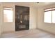 Cozy living room showcasing a modern fireplace, sleek hardwood floors, and abundant natural light from two large windows at 825 Cornerstone Pl, North Las Vegas, NV 89031