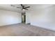Spacious primary bedroom featuring neutral paint, carpet flooring and a ceiling fan at 825 Cornerstone Pl, North Las Vegas, NV 89031