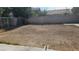An empty dirt backyard ready for landscaping with a block wall at 845 Bladensburg St, Las Vegas, NV 89110