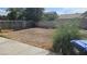 View of backyard space with tall shrub and fence in sunny weather at 845 Bladensburg St, Las Vegas, NV 89110