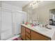 Bathroom with double sink vanity, tile floors, a framed mirror, and a standing shower at 845 Bladensburg St, Las Vegas, NV 89110