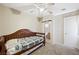 Bedroom with neutral walls, carpet, wood daybed with dark wood frame, and access to bathroom at 845 Bladensburg St, Las Vegas, NV 89110