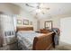 This bedroom features neutral walls, carpet, a ceiling fan, and a wood bed frame at 845 Bladensburg St, Las Vegas, NV 89110