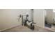 Carpeted room has a weight bench, dumbbells, and access to the bathroom at 845 Bladensburg St, Las Vegas, NV 89110