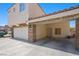 Exterior view featuring garage with stone facade and attached porte-cochere at 845 Bladensburg St, Las Vegas, NV 89110