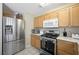 Kitchen with stainless refrigerator and ample counter space at 845 Bladensburg St, Las Vegas, NV 89110