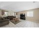 Living room with tile floors, couch, coffee table, and large television at 845 Bladensburg St, Las Vegas, NV 89110