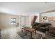 Spacious living room with a large window and stairs, tiled floors, and neutral colored walls at 845 Bladensburg St, Las Vegas, NV 89110